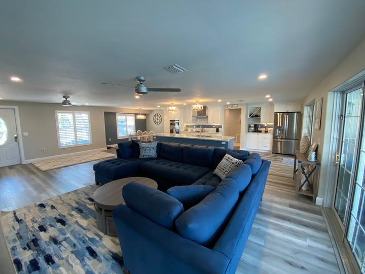 Open great room with sectional and kitchen