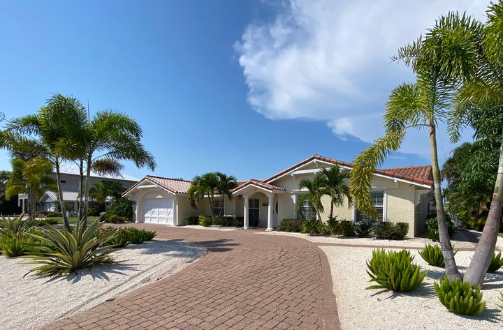 Front of the home with palms